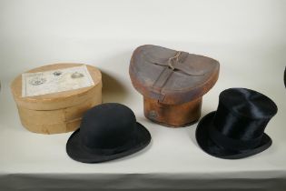 A vintage G.A. Dunn & Co bowler hat, a vintage silk top hat, an antique leather top hat case and a