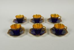 An antique Coalport porcelain cabaret set of six cups and saucers, in cobalt blue and gilt, saucer
