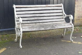 A painted metal garden bench with lion mask decoration, 126cm wide