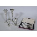 A pair of hallmarked silver dwarf candlesticks, 10cm high, and a pair of hallmarked silver vases,