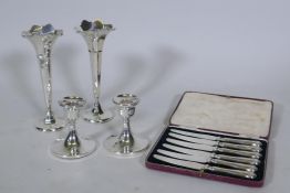 A pair of hallmarked silver dwarf candlesticks, 10cm high, and a pair of hallmarked silver vases,