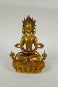 A Tibetan gilt bronzed metal figure of Buddha, double vajra mark to base, 20cm high