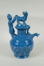 A Chinese teal glazed porcelain pourer decorated with Fo dogs and figures, mark to base, 29cm high