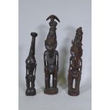 Three Papua New Guinea carved wood tribal figures, largest 64cm high