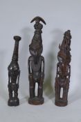 Three Papua New Guinea carved wood tribal figures, largest 64cm high