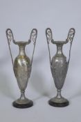A pair of silver plated Art Nouveau style urns with Grecian decoration, AF, 57cm high