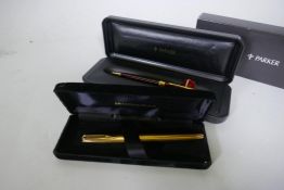 A Watermans gold plated fountain pen with 18ct nib in box, appears unused, and a Parker Sonnet