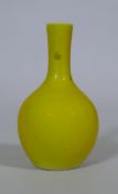 A Chinese famille jaune glazed bottle shaped vase, seal mark to base, 18cm high