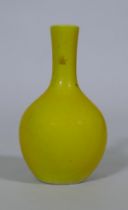 A Chinese famille jaune glazed bottle shaped vase, seal mark to base, 18cm high