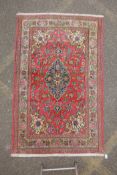 A very fine hand woven Persian Kashan rug with floral medallion design on a pink field, patched, 172