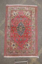 A very fine hand woven Persian Kashan rug with floral medallion design on a pink field, patched, 172