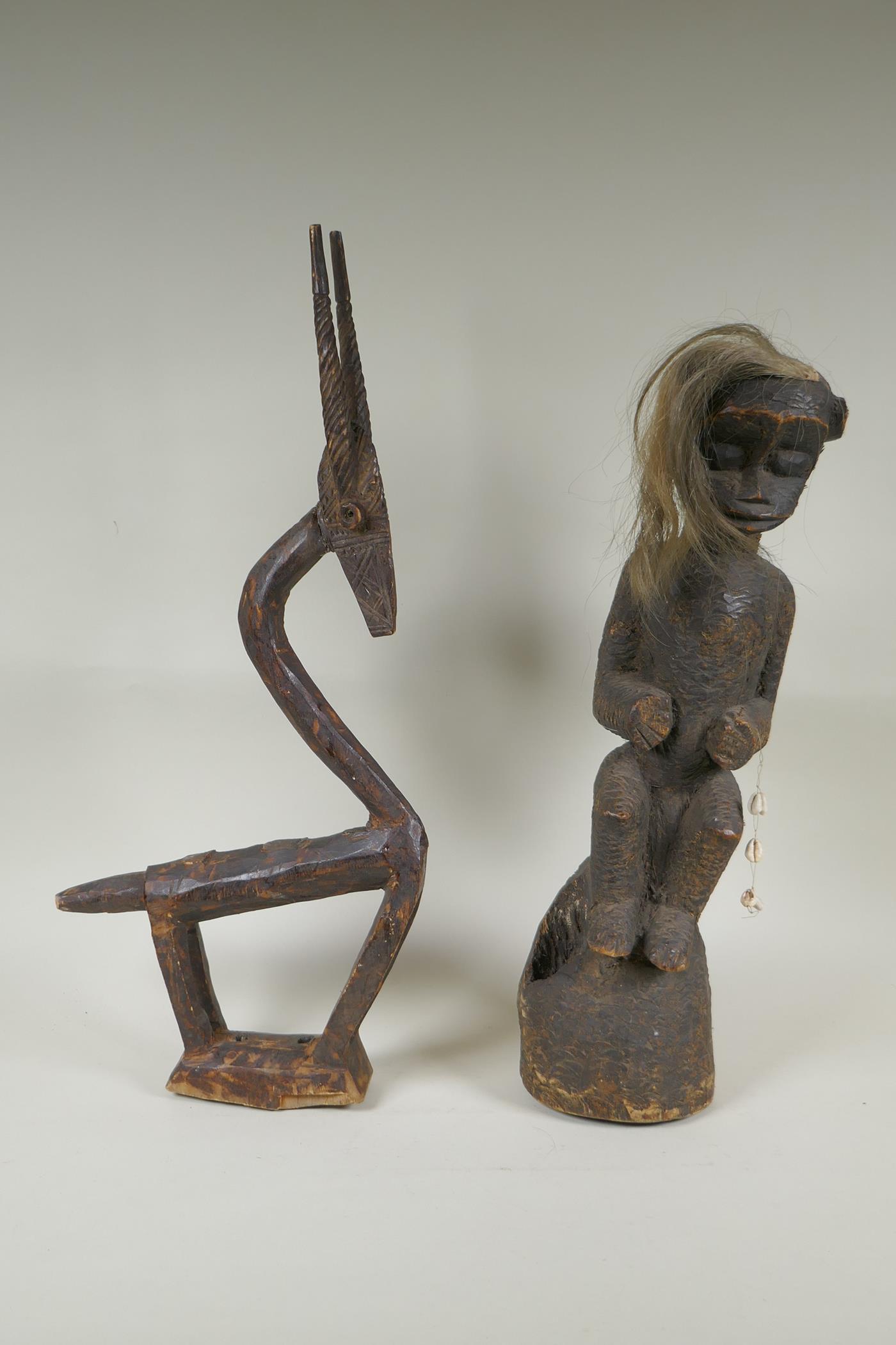 An African Bamana tribe carved wood Chi Wara antelope, together with a carved wood figure with