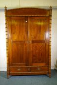 A Dutch C19th polished pitch pine knockdown armoire, with two doors flanked by faux bamboo