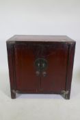 An antique Chinese red lacquered side cabinet with two doors, 78 x 50cm, 78cm high