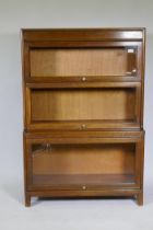 A Globe Wernicke style oak bookcase, two upper sections over a stepped lower, AF glass cracked, 87 x