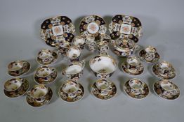 A Staffordshire Imari pattern six place tea set, with twelve spare cups, 42 pieces