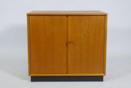 A mid-century Dynatron teak music cabinet with two doors and record dividers, 61 x 43 x 54cm