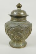 A Chinese gilt bronze meiping jar and cover, with raised decorative panels depicting asiatic animals