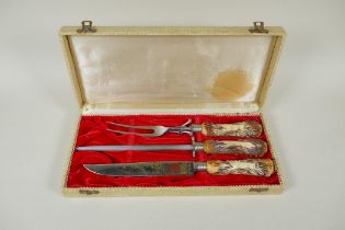 A cased carving set by Anton Wingen Jr of Solingen, Germany, with carved antler handles decorated