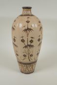 A Chinese Cizhou kiln pottery vase of ribbed form with painted bamboo style decoration, 32cm high,