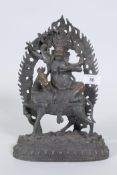 A Sino-Tibetan bronze figure of a deity on horseback, 32cm high
