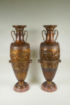 After Barbedienne, a pair of bronze Grand Tour style urns with two handles and raised figural