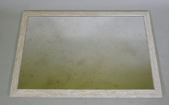 A painted and distressed wall mirror with a reeded frame and antiqued glass, 71 x 102cm