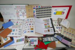 A large quantity of C19th, C20th and world postage stamps in albums, loose and attached to postcards
