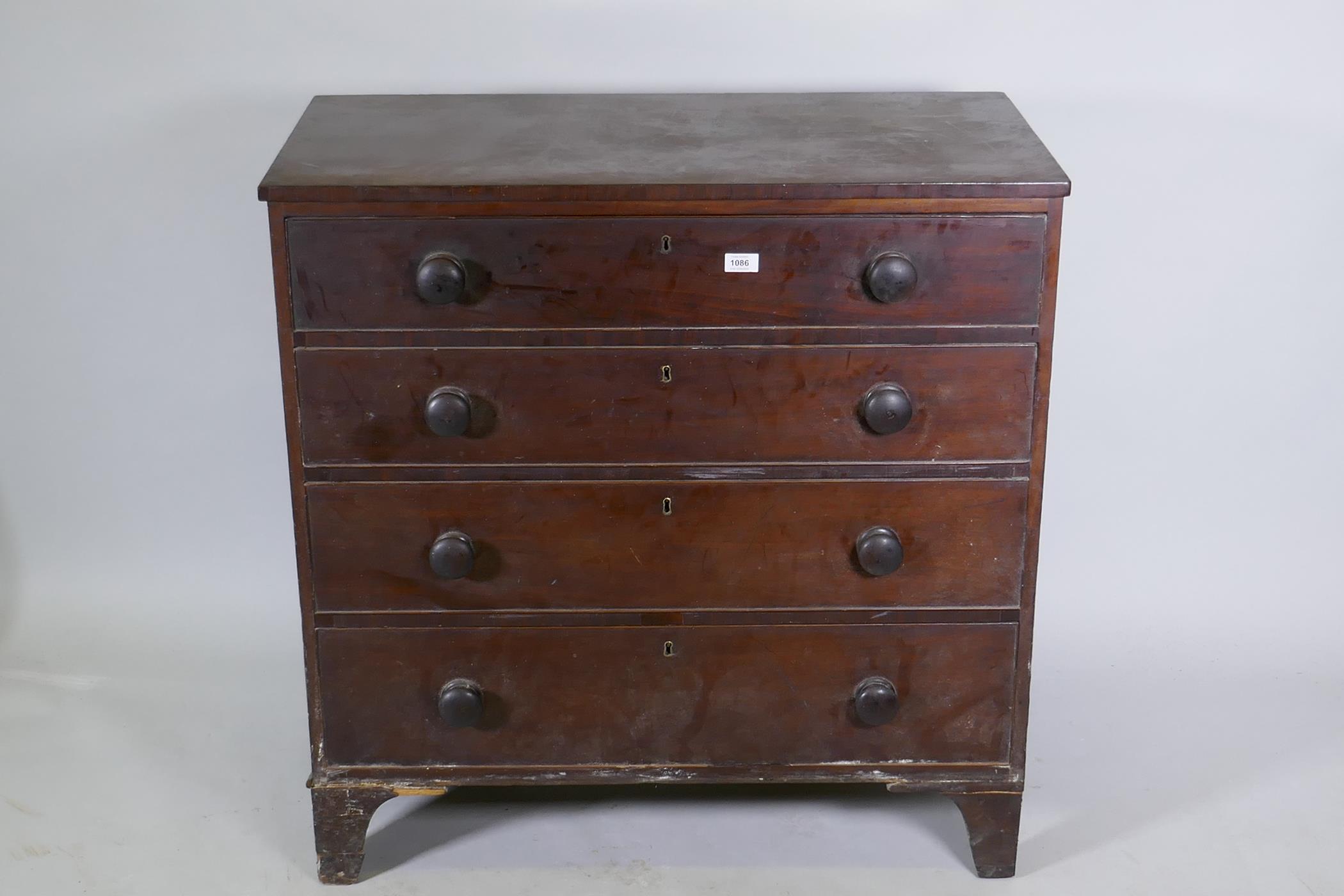 A Georgian mahogany chest of four long drawers, with cockbeaded detail and wooden knobs, raised on - Image 2 of 5