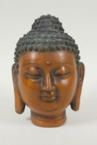 A Chinese filled bronze head bust of Buddha, impressed character mark to base, 19cm high