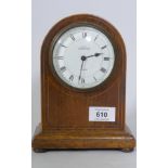 An Edwardian mahogany dome cased mantel clock, the enamel dial with Roman numerals inscribed