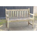 A weathered teak garden bench, 125cm wide