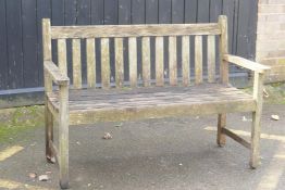 A weathered teak garden bench, 125cm wide