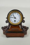 A C19th German mahogany cased mantel clock by Reinhold Schnekenburger, decorated with carved