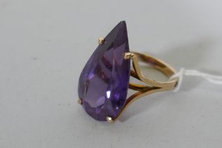 A vintage 14ct yellow gold dress ring set with a large amethyst coloured gemstone, Israeli hallmark,