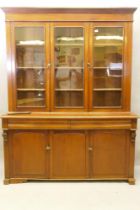 A C19th French stained fruitwood and walnut bookcase, the upper section with two glazed doors,