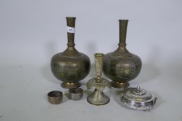 A pair of Indian brass vases with repousse decoration, 29cm high, a candlestick, a white metal