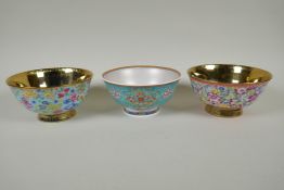A pair of Chinese gilt lustre and polychrome porcelain bowls with allover floral decoration, and