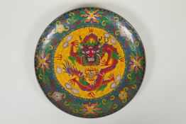 A Chinese cloisonne dish decorated with a dragon and flaming pearl, 25cm diameter