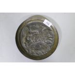 A Sasanian style cast bronze dish with raised decoration depicting a lion hunt, 20cm diameter