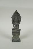 A Cambodian filled bronze figure of Buddha seated on a cobra throne, 22cm high