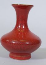 A Chinese streaked red glazed ceramic vase, seal mark to base, 14cm high