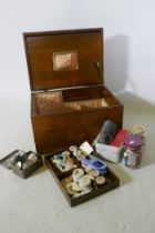 An oak workbox containing vintage buttons and threads, 38 x 28 x 23cm