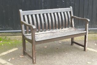 A varnished teak garden bench, 123cm wide