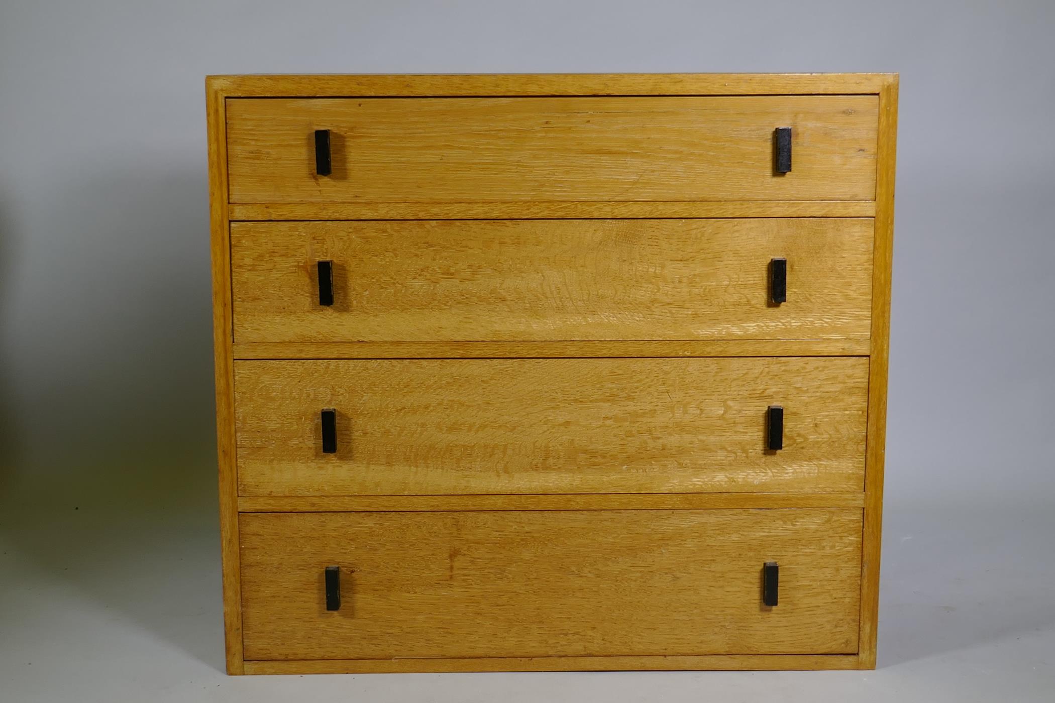 A mid-century oak chest of four long drawers, 92 x 43 x 83cm
