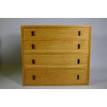 A mid-century oak chest of four long drawers, 92 x 43 x 83cm