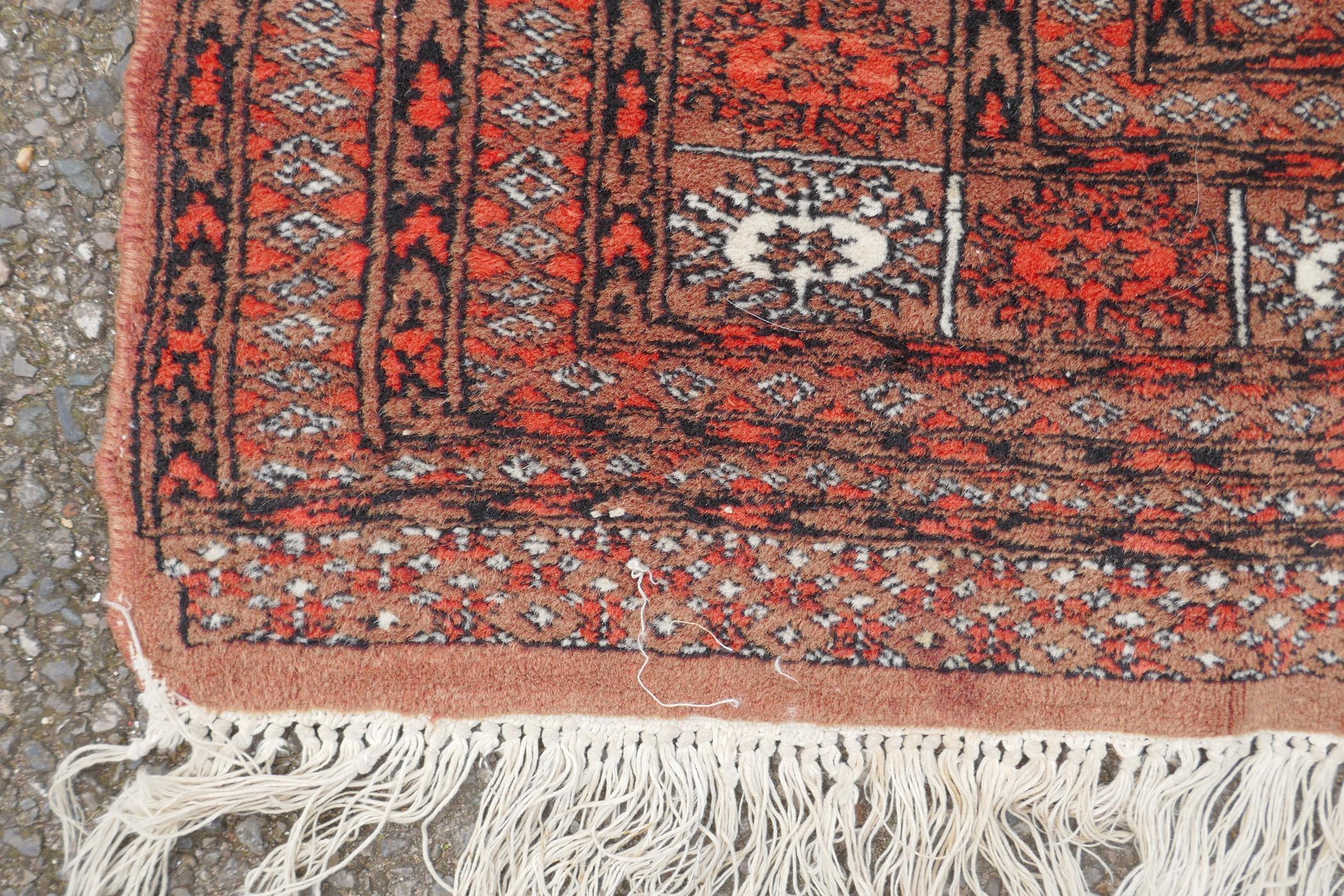 A red ground Bokhara rug with brown and orange borders, 128 x 175cm - Image 4 of 6