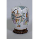 A Chinese famille verte jar and cover, decorated with women and five boys in a garden, with