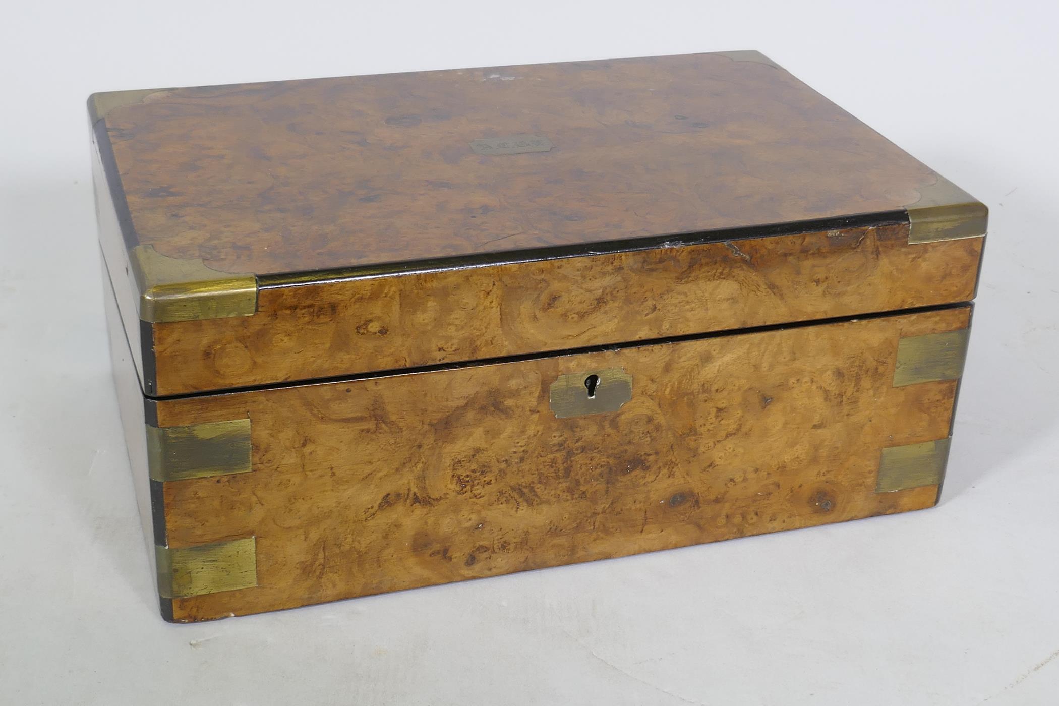 A Victorian burr walnut writing slope with brass mounts and fitted interior with inset leather slope