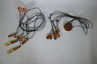 Two coppered metal spider pendant lights with six strands